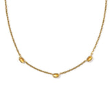 Gold necklace with three yellow gemstones on a white background