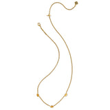 Gold necklace with small beads on a white background