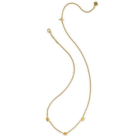 Gold necklace with small beads on a white background