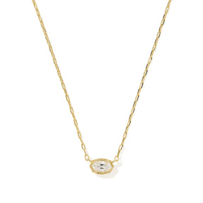 A delicate gold chain necklace featuring an oval pendant with a small clear central stone surrounded by a halo of tiny clear stones, set against a plain white background.