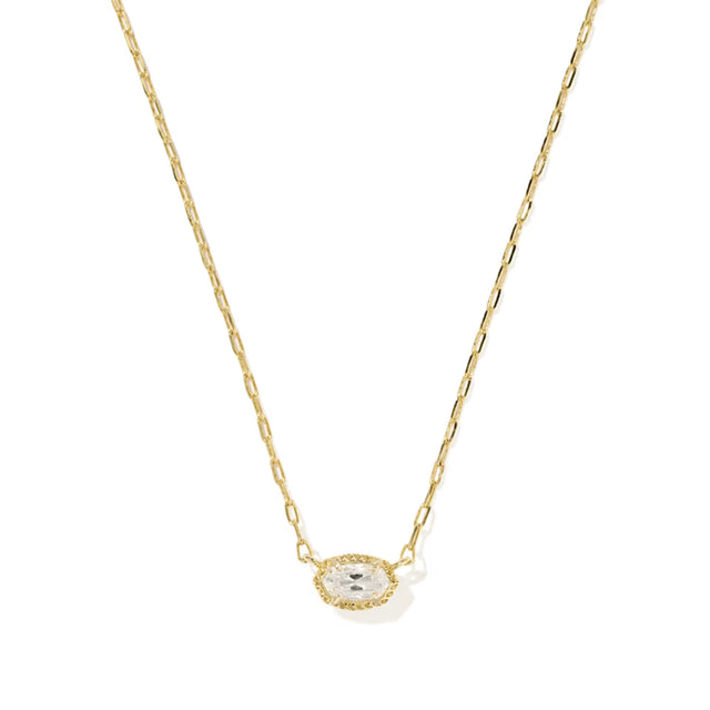 A delicate gold chain necklace featuring an oval pendant with a small clear central stone surrounded by a halo of tiny clear stones, set against a plain white background.