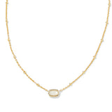 A delicate gold chain necklace featuring a central oval bezel-set white stone, displayed on a clean white background.