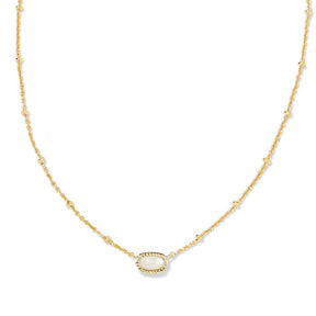 A delicate gold chain necklace featuring a central oval bezel-set white stone, displayed on a clean white background.