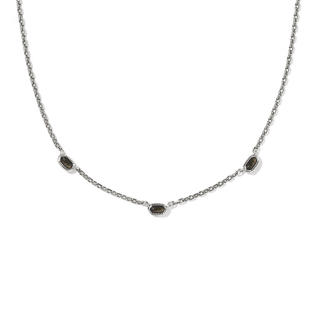 Necklace with small dark stones on a white background