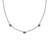Necklace with small dark stones on a white background