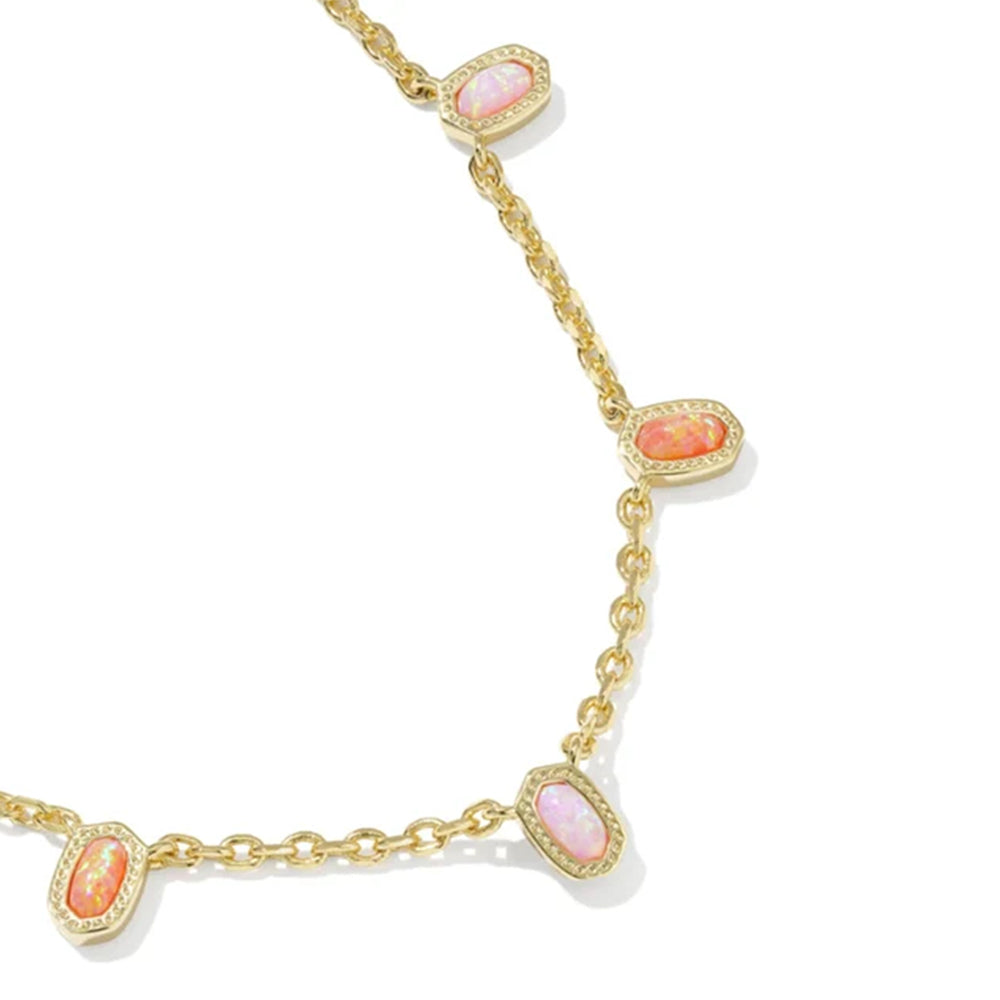 A gold chain necklace featuring four oval pink opal-like gemstones, each surrounded by a halo of small clear stones, set against a plain white background.