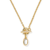 A gold chain necklace with a toggle clasp pendant and a dangling teardrop-shaped clear stone, shown on a plain white background.