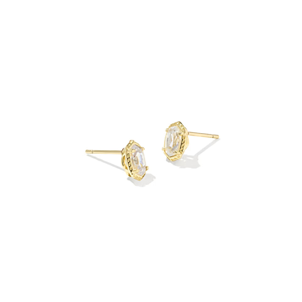 A pair of gold stud earrings with marquise-cut clear gemstones in a textured bezel setting, shown on a plain white background.