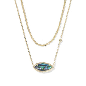 A double-strand gold necklace featuring a textured chain and a central marquise-shaped pendant with an iridescent abalone shell inlay and a small clear crystal accent.