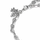 A close-up of a silver chain bracelet featuring a small cross charm and a heart-shaped accent, set against a plain white background.