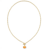 Gold necklace with a small pumpkin pendant on a white background