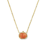 A gold chain necklace featuring a small pumpkin-shaped pendant with a carved orange-pink center and a border of tiny clear stones, shown on a plain white background.