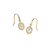 A pair of gold dangle earrings featuring oval milky white stones surrounded by small clear stones, set against a plain white background.