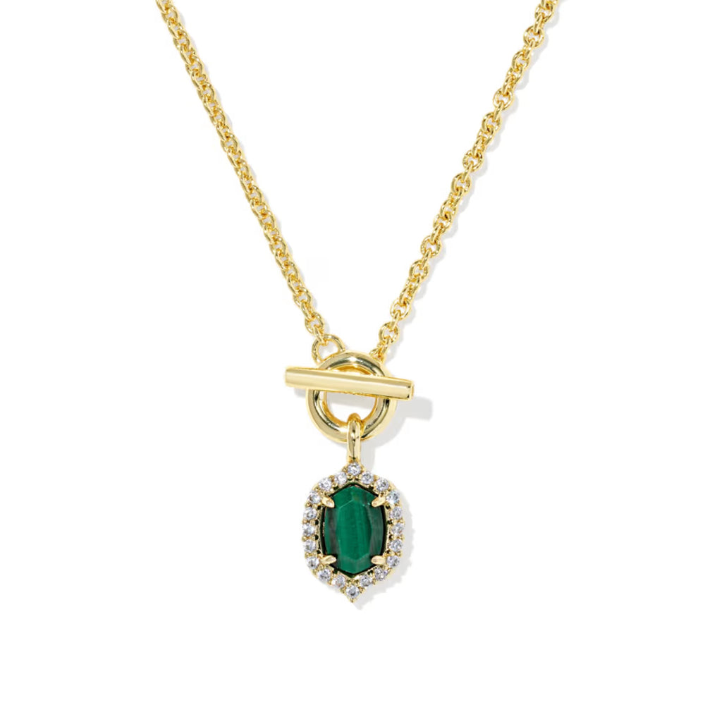 A gold chain necklace with a toggle clasp and a pendant featuring a green emerald-cut center stone surrounded by small clear stones, shown on a white background.