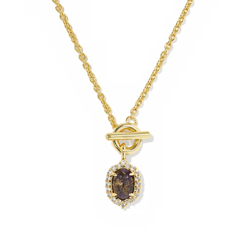 A gold chain necklace with a toggle clasp and a teardrop-shaped pendant featuring a dark brown oval center stone surrounded by small clear stones, shown on a plain white background.