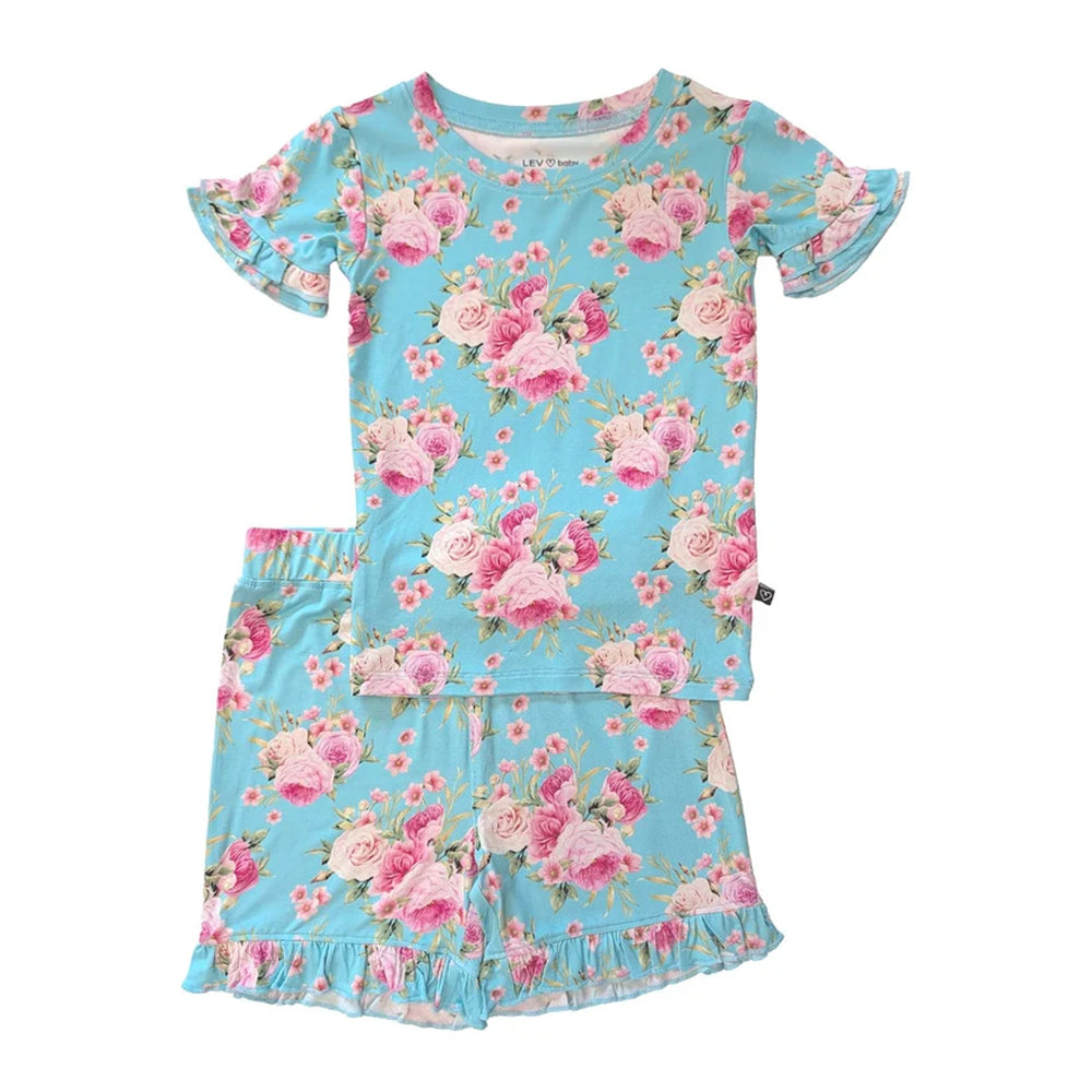 A two-piece girls' pajama set featuring a short-sleeve top and matching shorts in light blue with a pink and white floral rose print, displayed on a solid white background.