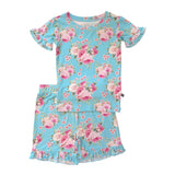 A two-piece girls' pajama set featuring a short-sleeve top and matching shorts in light blue with a pink and white floral rose print, displayed on a solid white background.