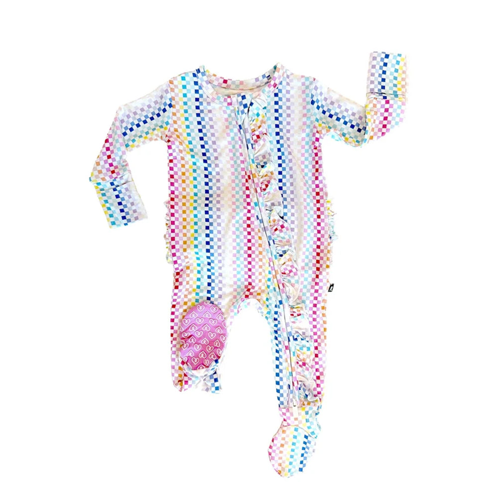 A baby long-sleeve footed sleeper with a colorful rainbow checkered pattern on a white base, featuring a pink belly patch and snap-button front closure.