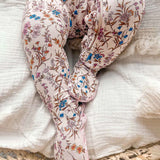 Floral-patterned baby romper on a textured surface