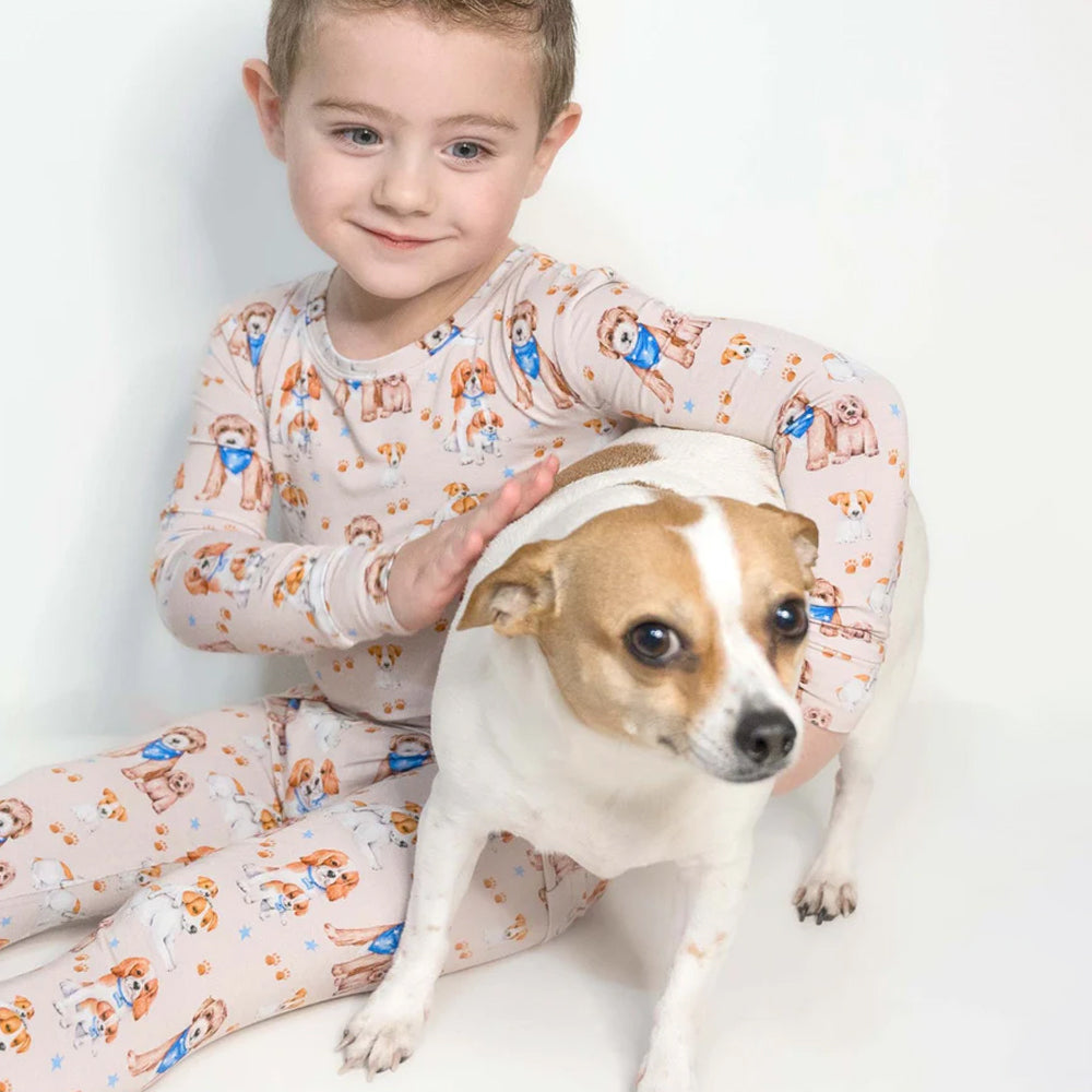 Child in pajamas with a dog on a white background
