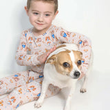 Child in pajamas with a dog on a white background