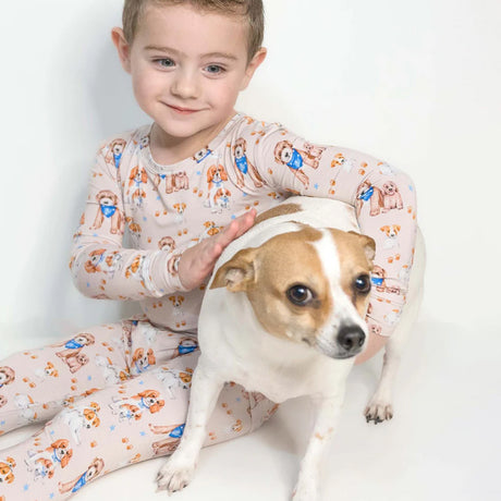 Child in pajamas with a dog on a white background