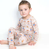 Child wearing a patterned pajamas with dogs on a white background