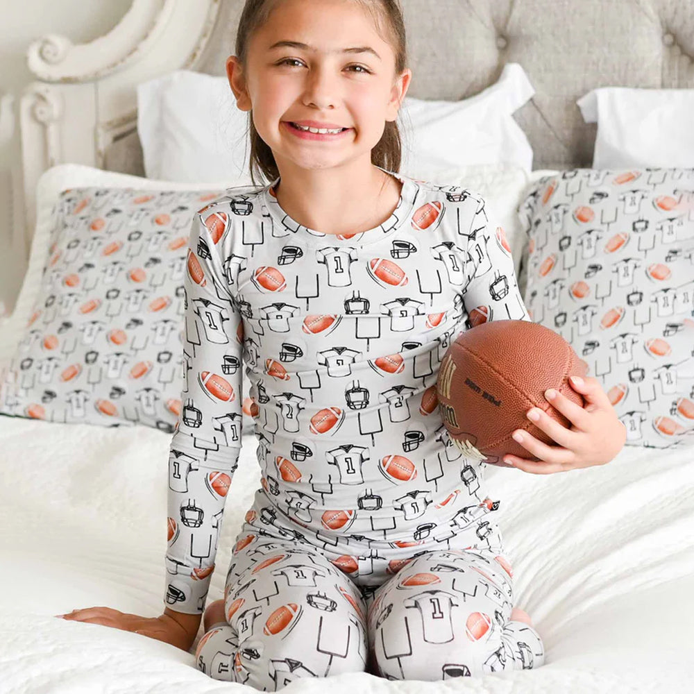 Child wearing a sports-themed pajamas with a smile