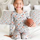 Child wearing a sports-themed pajamas with a smile