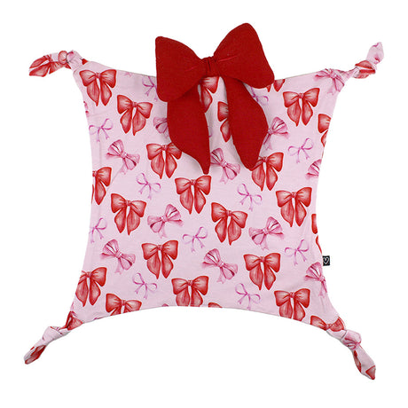 Decorative pillow with red and pink bow pattern on a white background
