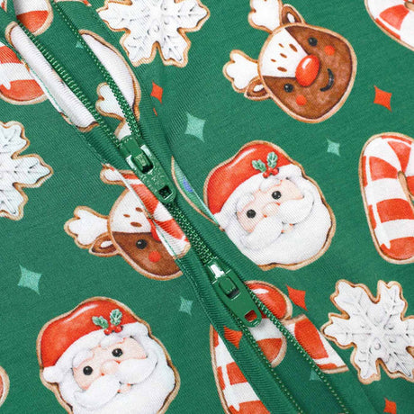 Green fabric with Christmas-themed pattern featuring Santa Claus, candy canes, and cookies with a zipper running along the center.