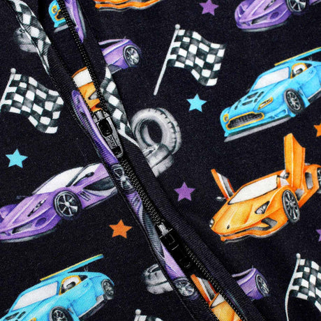 Close-up of a fabric with race car and flag pattern on a black background