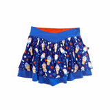 A blue pleated skater skirt featuring an all-over patriotic ice cream and star pattern, with a solid blue waistband and a bright orange inner lining visible at the top, shown against a plain white background.
