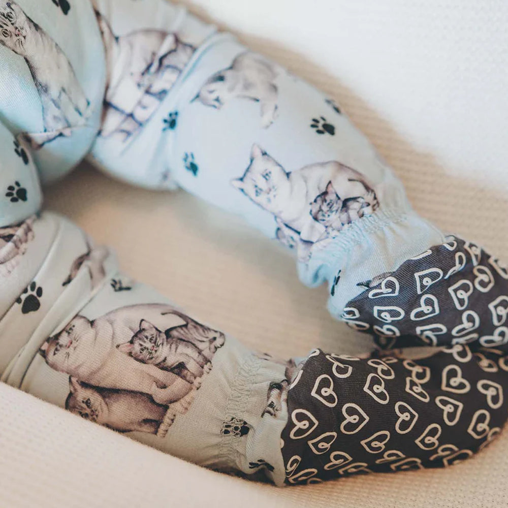 Collage of cat-themed fabric with various patterns on a white background