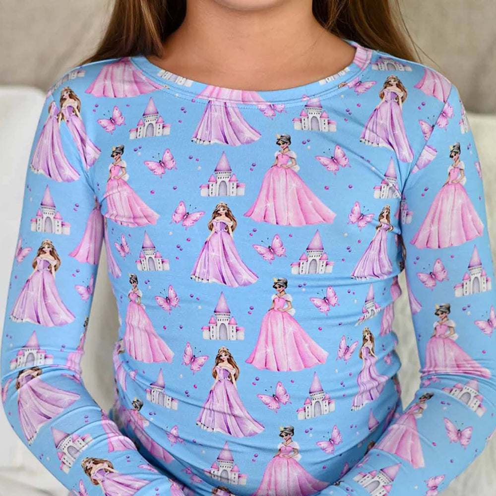 Children's long-sleeve shirt with princess and castle pattern on a blue background