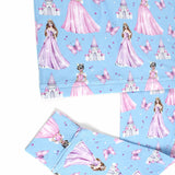 Princess-themed fabric with pink dresses, castles, and butterflies on a blue background.