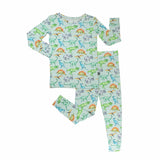 Children's pajama set with dinosaur pattern on a light blue background