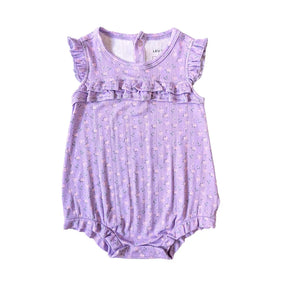 A lavender baby romper with a small floral print, featuring ruffle trim at the neckline and sleeve hems, laid flat on a white background.