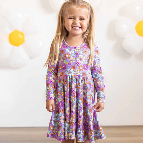 Young girl wearing a floral dress with a white background