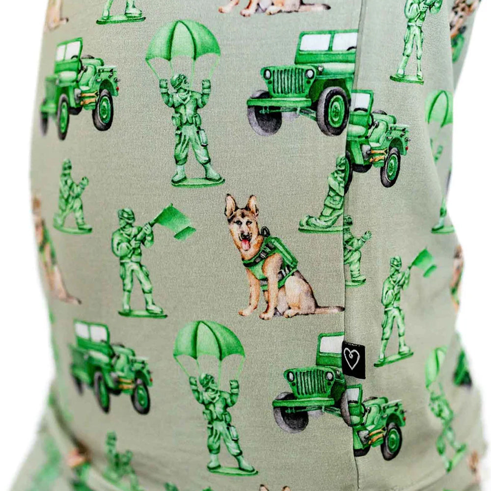 Fabric with green toy soldiers, jeeps, and a dog on a gray background