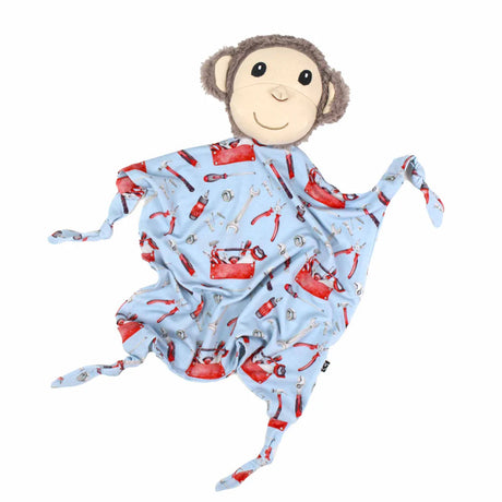 Monkey plush toy with a blue blanket featuring red tool patterns on a white background