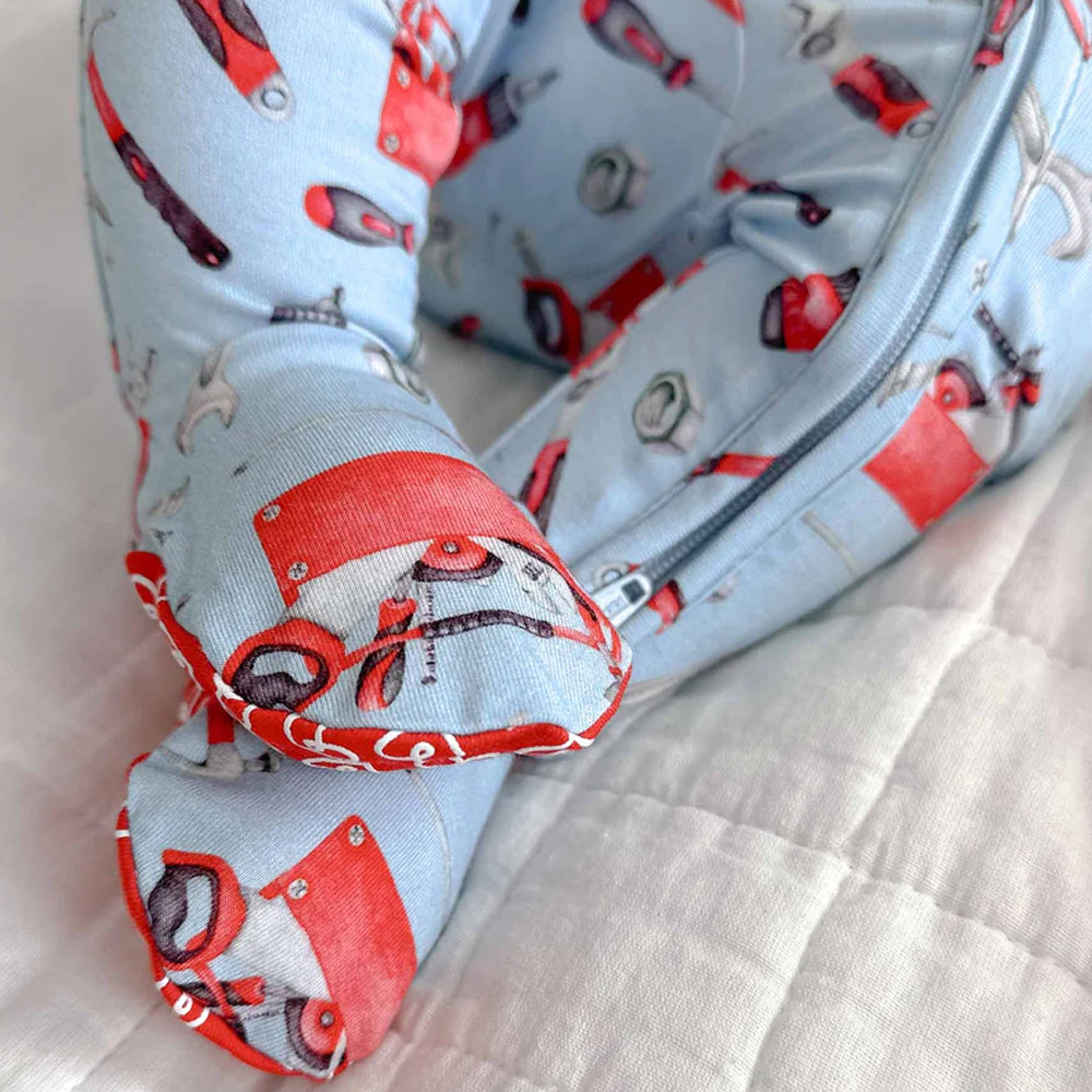 Fabric with red and gray tool pattern on a light blue background