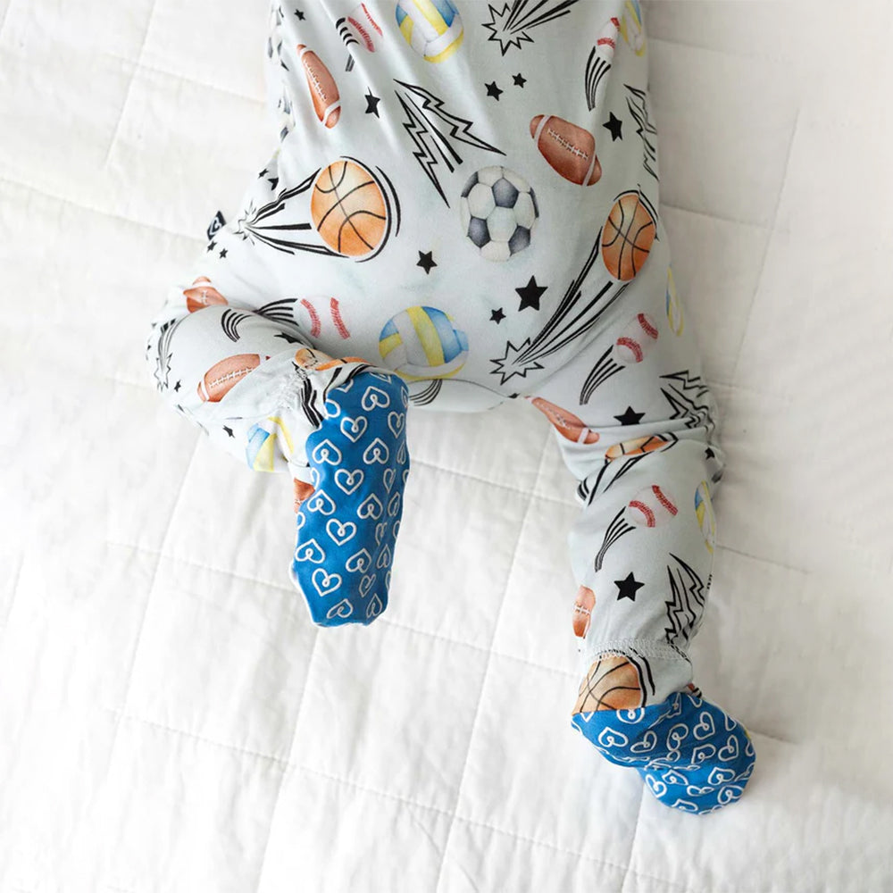 Baby onesie with sports-themed print on a white background