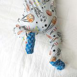Baby onesie with sports-themed print on a white background