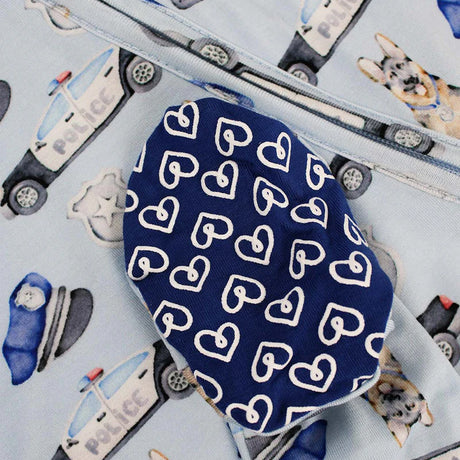 Blue fabric with white heart patterns on a background of police car illustrations