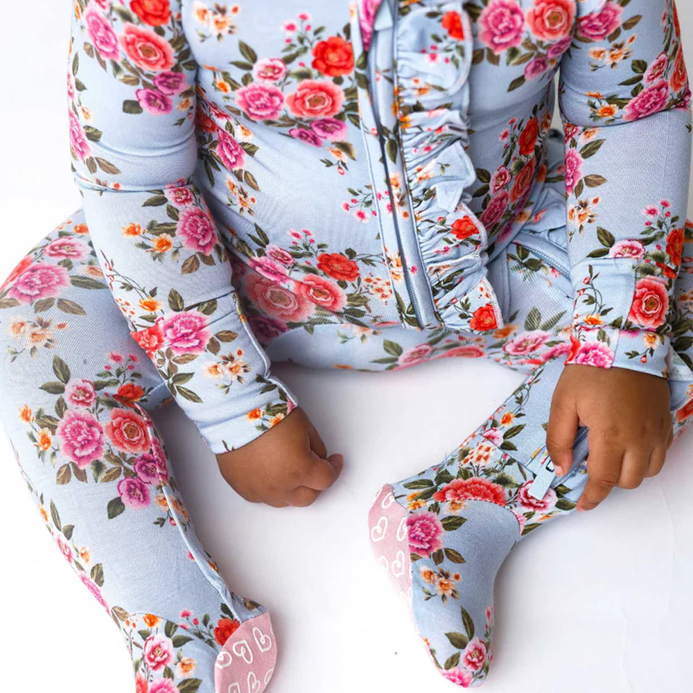 Floral-patterned baby onesie on a white background