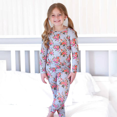 Young girl wearing a floral pajama set in a bedroom setting