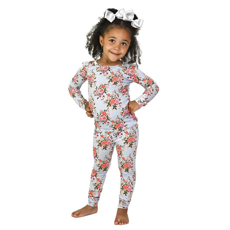 Child wearing a floral pajama set on a white background