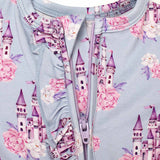 Children's outfit with castle and floral pattern on a light blue background