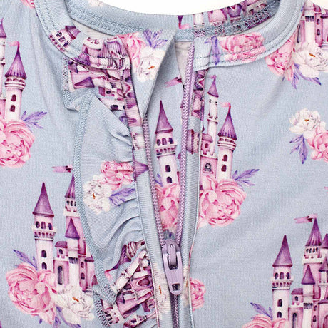 Children's outfit with castle and floral pattern on a light blue background